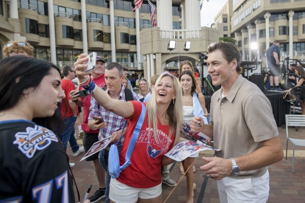 T.J. Oshie poses for selfies with fans after announcing his retirement at Washington Harbor on June 9, 2025. (AP Photo/Rod Lamkey, Jr.)