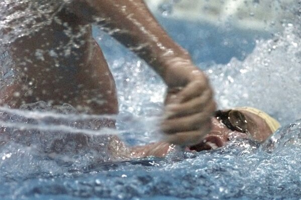 FILE - Kieren Perkins of Australia competes in the men's 1500 meter freestyle final at the 1996 Summer Olympic Games in Atlanta, Friday, July 26, 1996. Perkins won the gold medal. Two-time Olympic swimming gold medalist and Australian Sports Commission chief Perkins says “someone will die” if a multi-sport event that he called “borderline criminal” and which allows banned substances goes ahead. (AP Photo/David Longstreath, File)