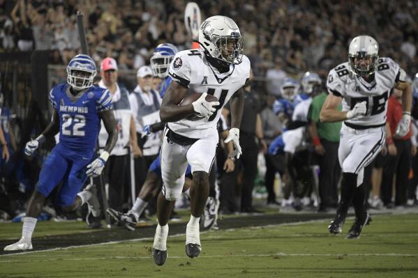 Central Florida wide receiver Ryan O'Keefe (4) runs into the end zone with a touchdown reception, as Memphis defensive back Tyrez Lindsey (22) watches during the first half of an NCAA college football game Friday, Oct. 22, 2021, in Orlando, Fla. (Phelan M. Ebenhack/Orlando Sentinel via AP)
