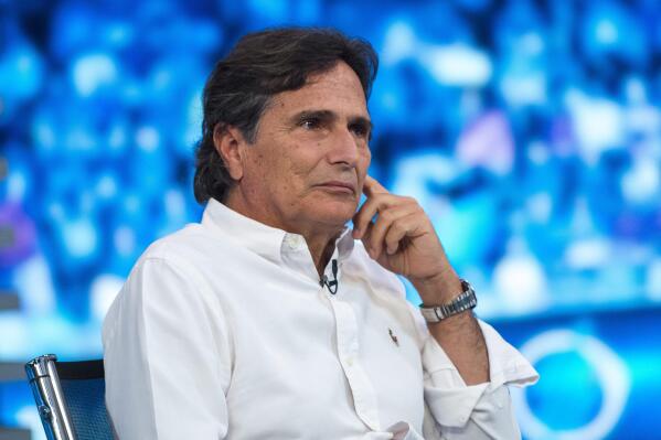FILE - Three-time world champion Formula One racer Nelson Piquet of Brazil attends the shooting of the Hungarian Television's Formula One magazine in Budapest, Hungary, on July 23, 2015. Retired Formula One champion Nelson Piquet has been ordered to pay $950,000 for making racist and homophobic comments about Lewis Hamilton. (Janos Marjai/MTI via AP, File)