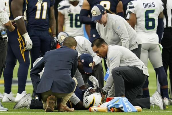 Los Angeles Chargers wide receiver Mike Williams (81) is checked out for injury during the second half of an NFL football game against the Seattle Seahawks Sunday, Oct. 23, 2022, in Inglewood, Calif. (AP Photo/Marcio Jose Sanchez)