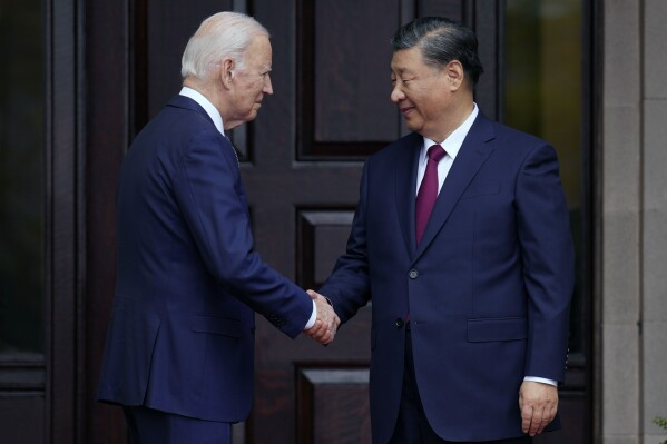 FILE - President Joe Biden, left, greets China's President President Xi Jinping, right, in Woodside, USA, Nov. 15, 2023. High-level envoys from the United States and China are set to meet in Geneva for talks about artificial intelligence including the risks of the technology and ways to set shared standards to manage it. The meeting Tuesday is billed as an opening exchange of views in an inter-governmental dialogue on AI agreed during a meeting between U.S. President Joe Biden and Chinese President Xi Jinping in San Francisco. (Doug Mills/The New York Times via AP, Pool, File)