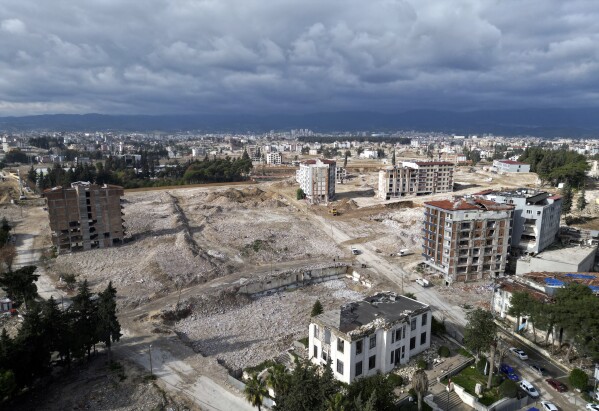 Arial view shows the cleared rubble of buildings destroyed by the Feb. 2023 earthquake in the city of Antakya, southern Turkey, Thursday, Jan. 11, 2024. A year after the devastating 7.8 magnitude earthquake struck southern Turkey and northwestern Syria, a massive rebuilding effort is still trudging along. The quake caused widespread destruction and the loss of over 59,000 lives. (AP Photo/Khalil Hamra)