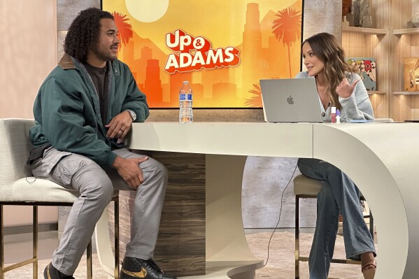 In this photo provided by FanDuel TV, Kay Adams, right, interviews Los Angeles Chargers linebacker Eric Kendricks, left, during an episode of "Up and Adams" at the FanDuel TV studios in Los Angeles in April 2023. FanDuel TV has embraced the growth of legal sports betting across the U.S. in its first year. It has also remained true to its roots as the channel for horse racing. FanDuel TV marked its first anniversary on Sept. 1, 2023, after being rebranded from TVG. (David Crown/FanDuel TV via AP)