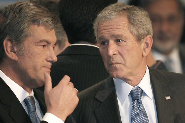 FILE - Ukraine's President Viktor Yushchenko talks with US President George W.Bush, at the NATO Summit conference in Bucharest, Thursday April 3, 2008. NATO returns on Tuesday, Nov. 29, 2022 to the scene of one of its most controversial decisions and where it intends to repeat its vow that Ukraine, now suffering through the tenth month of a war against Russia, will be able to join the world's biggest military alliance one day.(AP Photo/Vadim Ghirda, File)