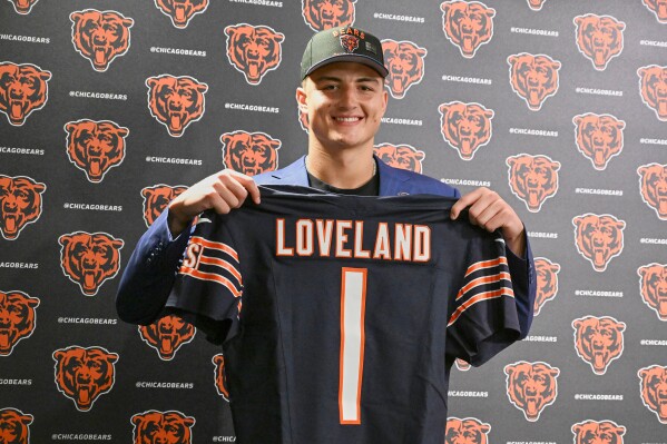 Tight end Colston Loveland, the Chicago Bears' first round draft pick, 10th overall, shows off his jersey during an NFL football press conference, Friday, April 25, 2025, in Lake Forest, Ill. (AP Photo/Matt Marton)