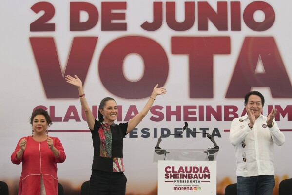 FILE - Ruling party presidential candidate Claudia Scheinbaum, center left, surrounded by mayoral candidate Clara Brugada and Morena party leader Mario Delgado, addresses supporters during a campaign rally in Mexico City, May 16, 2024. (AP Photo/Marco Ugarte, File)