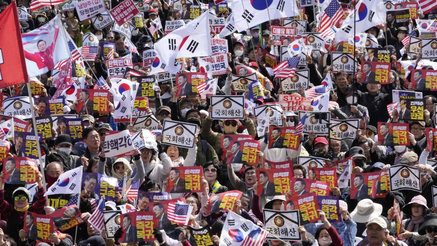 Huge crowds march in rival rallies for and against South Korea’s impeached president