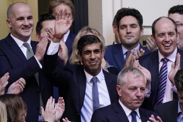 Rishi Sunak, centre, waves after winning the Conservative Party leadership contest at the Conservative party Headquarters in London, Monday, Oct. 24, 2022. Former British Treasury chief Rishi Sunak is frontrunner in the Conservative Party's race to replace Liz Truss as prime minister. (AP Photo/Aberto Pezzali)