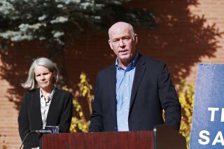 Montana Gov. Greg Gianforte speaks outside St. James Health hospital in Butte, Mont., Thursday, Oct. 21, 2021. Gianforte announced the state had helped set up a monoclonal antibody infusion clinic at the hospital, run by a private contractor, to treat people with COVID-19 and help prevent hospitalizations. Acting state Medical Officer Maggie Cook-Shimanek stands behind him. (Meagan Thompson/The Montana Standard via AP)
