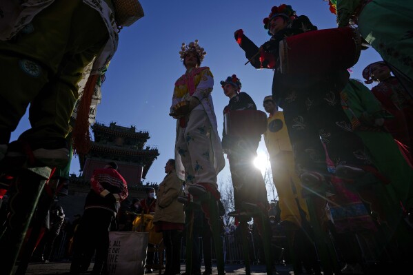 Chinese performers dressed in traditional costumes wait to participate in a performance at the Dongyue Temple during the first day of the Chinese Lunar New Year in Beijing, Saturday, Feb. 10, 2024. (AP Photo/Andy Wong)