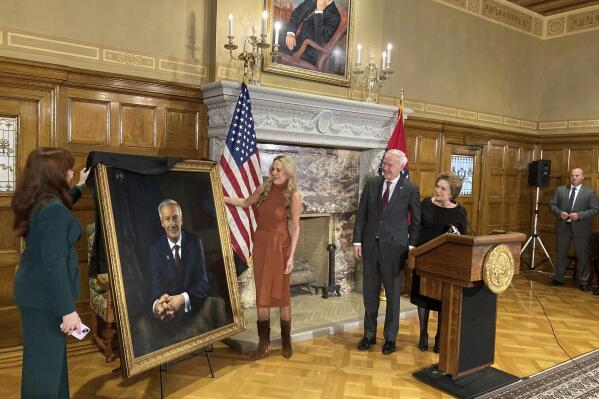 CORRECTS NAME TO SARAH WENGEL, NOT SUSAN WENGEL -Arkansas Gov. Asa Hutchinson and first lady Susan Hutchinson look on as their granddaughter, Jaella Wengel, left, and daughter, Sarah Wengel, center, unveil the governor's official portrait on Tuesday, Jan. 3, 2023, at the state Capitol in Little Rock, Ark. Hutchinson will leave office on Jan. 10 after serving eight years as governor. (AP Photo/Andrew DeMillo)