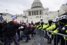 FILE - Violent insurrectionists loyal to then-President Donald Trump try to break through a police barrier, Wednesday, Jan. 6, 2021, at the Capitol in Washington. (AP Photo/Julio Cortez, File)