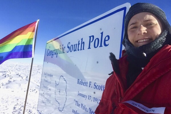 In this photo provided by Jennifer Sorensen, a sign and flag are installed at the South Pole, Nov. 15, 2021. From Sunday, Oct. 1, 2023, workers at the main United States base in Antarctica will no longer be able to walk into a bar and order a beer, after the federal agency which oversees the research program on the ice decided to stop serving alcohol. (Jennifer Sorensen via AP)