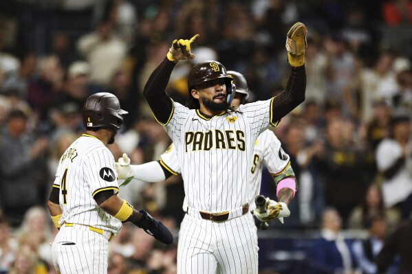 San Diego Padres' Fernando Tatis Jr. celebrates after scoring on a single hit by Jurickson Profar against the Oakland Athletics in the fifth inning of a baseball game Tuesday, June 11, 2024, in San Diego. Luis Arraez also scored on the play. (AP Photo/Derrick Tuskan)