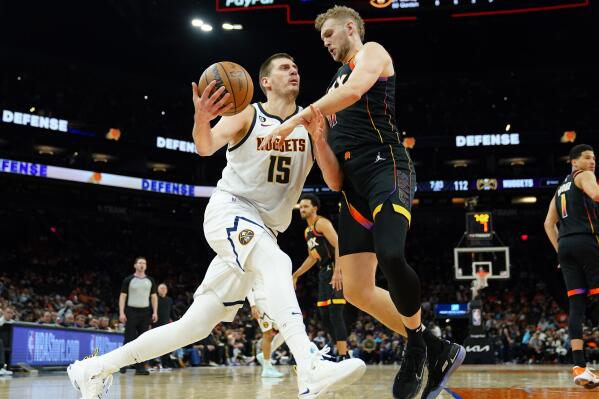Denver Nuggets center Nikola Jokic (15) drives on Phoenix Suns center Jock Landale during the second half of Game 6 of an NBA basketball Western Conference semifinal game, Thursday, May 11, 2023, in Phoenix. The Nuggets eliminated the Sun in their 125-100 win. (AP Photo/Matt York)