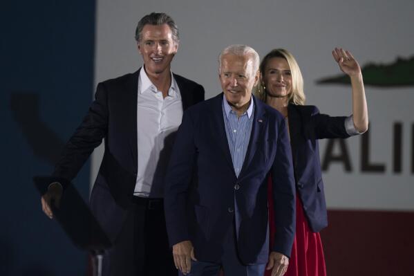 FILE — In this Sept. 13, 2021, file photo President Joe Biden, center, smiles to the crowd as he is flanked by California Gov. Gavin Newsom and Jennifer Siebel Newsom at a rally ahead of the California gubernatorial recall election in Long Beach, Calif. In the recall election, Newsom won big in coastal urban areas such as Los Angeles County, while the pro-recall side performed better in California's Central Valley and northern areas. (AP Photo/Jae C. Hong, File)