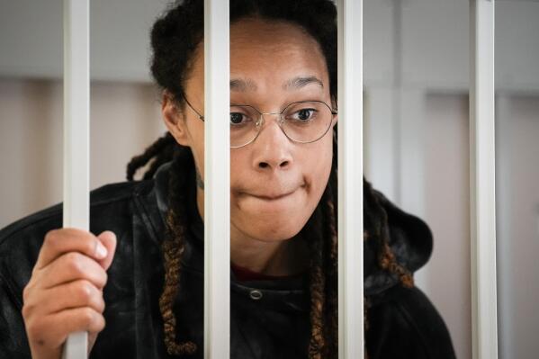 FILE - WNBA star and two-time Olympic gold medalist Brittney Griner speaks to her lawyers standing in a cage at a court room prior to a hearing, in Khimki just outside Moscow, Russia, Tuesday, July 26, 2022. A Russian court has on Tuesday, Oct. 23 started hearing American basketball star Brittney Griner's appeal against her nine-year prison sentence for drug possession. (AP Photo/Alexander Zemlianichenko, Pool, File)