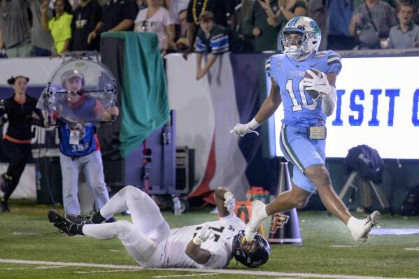 Tulane wide receiver Shae Wyatt (10) breaks free for a touchdown run against Central Florida linebacker Jason Johnson (15) during the second half of the American Athletic Conference championship NCAA college football game in New Orleans, Saturday, Dec. 3, 2022. (AP Photo/Matthew Hinton)