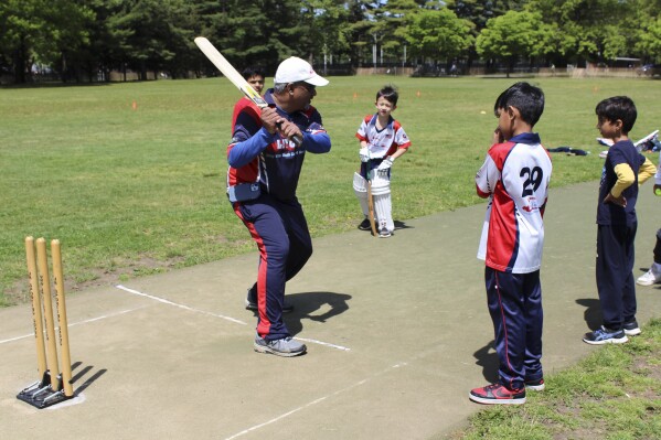 Parmanand Sarju, founder of the Long Island Youth Cricket Academy, instructs players during practice at Eisenhower Park in East Meadow, N.Y. on Saturday, May 11, 2024. " A temporary stadium for next month's T20 Cricket World Cup -- the first major international cricket competition the U.S. is hosting -- is being built atop another ball field in the park where Sarju's academy began more than a decade ago. (Ǻ Photo/Phil Marcelo)