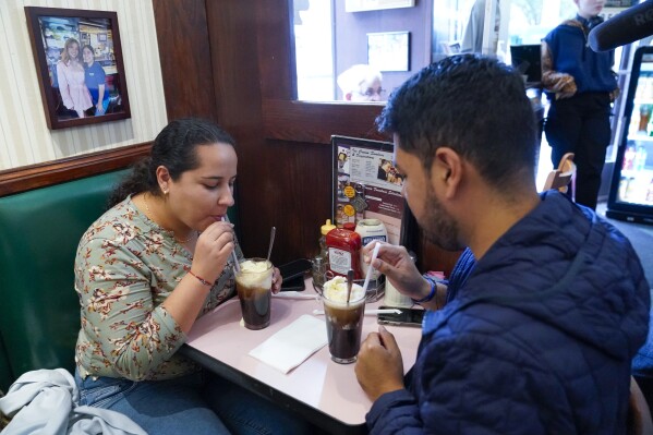 Customers enjoy Coke floats at the Lexington Candy Shop, Thursday, Sept. 28, 2023, in New York. The old school business met the new world when Nicolas Heller, a TikToker and Instagrammer with 1.2 million followers, popped in for a traditional Coke float. Naturally, he made a video. It went viral, garnering 4.8 million likes. (AP Photo/Mary Altaffer)