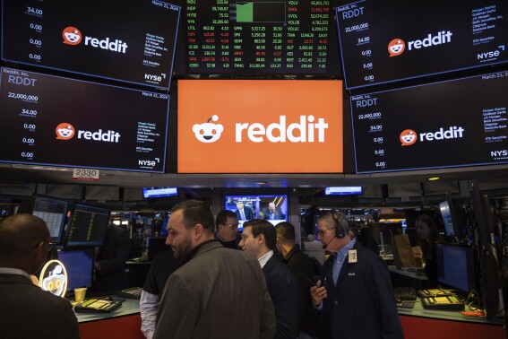 FILE - Reddit Inc. signage is seen on the New York Stock Exchange trading floor, prior to Reddit IPO, Thursday, March. 21, 2024. OpenAI and Reddit are teaming up in a deal that will bring the social media platform's content to ChatGPT. Shares of Reddit jumped 17% before the market open on Friday, May 17. (Ǻ Photo/Yuki Iwamura, File)