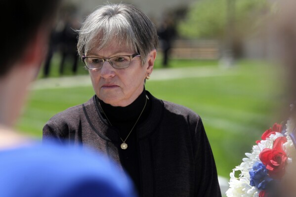 Kansas Gov. Laura Kelly participates in a ceremony honoring fallen law enforcement officers, Friday, May 3, 2024, outside the Statehouse in Topeka, Kan. Republican legislators have overridden Kelly's veto of budget provisions giving the Kansas National Guard a $15.7 million mission to help Texas with border security, but Kelly says she determines as the guard's commander how its resources are used, not legislators. (AP Photo/John Hanna)