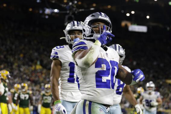 Dallas Cowboys' Tony Pollard (20) celebrates scoring a touchdown during the second half of an NFL football game against the Green Bay Packers Sunday, Nov. 13, 2022, in Green Bay, Wis. (AP Photo/Matt Ludtke)