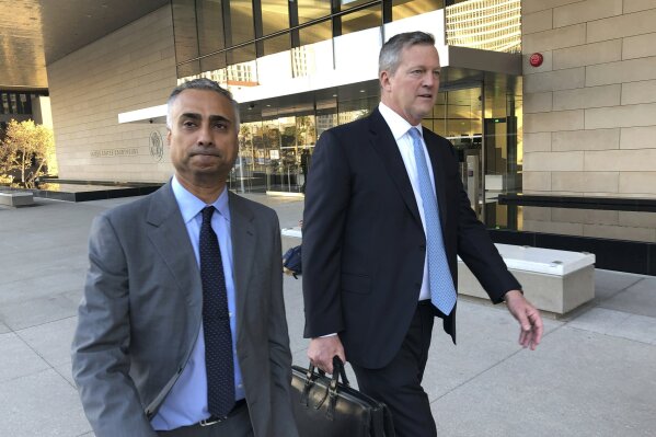 FILE - In this Nov. 22, 2019 file photo, Imaad Zuberi, left, leaves the federal courthouse in Los Angeles with his attorney Thomas O'Brien, right, after pleading guilty to funneling donations from foreigners to U.S. political campaigns.  Zuberi, an elite political fundraiser, had the ear of top Democrats and Republicans alike — a reach that included private meetings with then-Vice President Joe Biden and VIP access at Donald Trump’s inauguration. But federal prosecutors say Zuberi’s life was built on a series of lies and the lucrative enterprise of filling the campaign coffers of American politicians and profiting from the resulting influence. They describe him as a “mercenary” political donor who gave to anyone -- often using foreign money given through illegal straw donors. (AP Photo/Brian Melley, File)