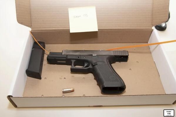 In this screen grab from video, a photo of a Glock 9mm handgun carried by Brooklyn Center police Officer Kim Potter is entered into evidence as Hennepin County Judge Regina Chu presides over court Monday, Dec. 13, 2021, in the trial of Potter in the April 11, 2021, death of Daunte Wright, at the Hennepin County Courthouse in Minneapolis, Minn. (Court TV via AP, Pool)