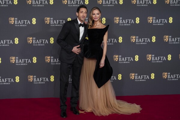 Adrien Brody, left, and Georgina Chapman pose for photographers upon arrival at the 78th British Academy Film Awards, BAFTA's, in London, Sunday, Feb. 16, 2025. (Photo by Alberto Pezzali/Invision/AP)