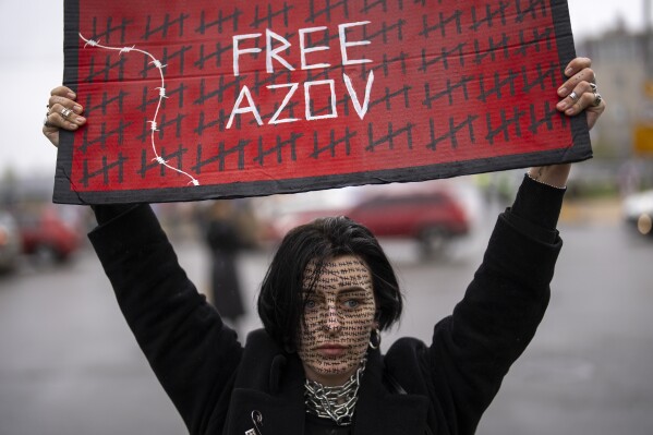 A woman mobilizes to raise awareness about the plight of Ukrainian prisoners of war in Kyiv, Ukraine, Sunday, April 21, 2024. (AP Photo/Francisco Seco)