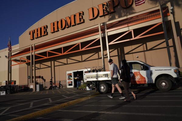 File - Customers arrive at a Home Depot store in the Van Nuys section of Los Angeles on July 24, 2023. The nation's labor board ruled on Wednesday that Home Depot violated federal labor law when it fired an employee for refusing to remove the hand-drawn "BLM" acronym for "Black Lives Matter" from his work apron. (AP Photo/Richard Vogel, File)