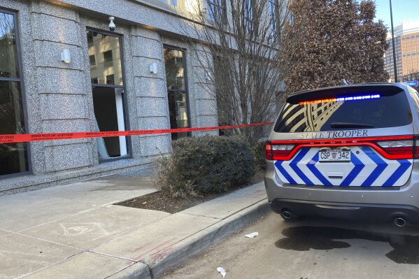 Police tape blocks the damage to large windows at the Colorado Supreme Court on Tuesday, Jan. 2, 2024 in Denver. Authorities say a man inflicted "extensive damage" to the building housing. (AP Photo/Colleen Slevin)