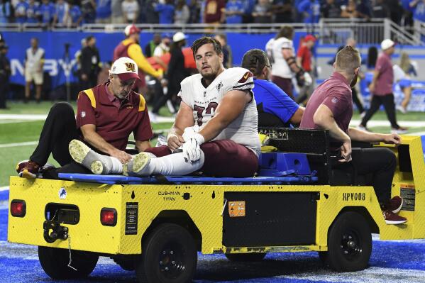 FILE - Washington Commanders center Chase Roullier (73) leaves the field on a cart after an injury during the second half of an NFL football game against the Detroit Lions Sunday, Sept. 18, 2022, in Detroit. The Washington Commanders are releasing center Chase Roullier with a post-June 1 designation, according to a person with knowledge of the decision. The person spoke to The Associated Press on condition of anonymity Friday, May 5, 2023, because the team had not announced the move. (AP Photo/Lon Horwedel, File)