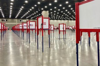 Voting stations are set up for the primary election at the Kentucky Exposition Center, Monday, June 22, 2020, in Louisville, Ky. With one polling place designated for Louisville on Tuesday, voters who didn’t cast mail-in ballots could potentially face long lines in Kentucky’s unprecedented primary election.  (AP Photo/Piper Blackburn)
