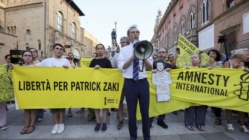 Protesters demonstrate in support of Patrick Zaki by the Piazza del Nettuno, in Bologna, Italy, Tuesday, July 18, 2023. An Egyptian court sentenced Zaki, a rights activist, on Tuesday to three years in prison over an opinion article he wrote in 2019 in a case that renewed global attention to Egypt's intolerance of government critics. He was arrested in February 2020 shortly after landing in Cairo on a short trip home from Italy where he was a postgraduate student at the University of Bologna. (Guido Calamosca/LaPresse via AP)