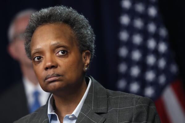 FILE - In this Friday, March 20, 2020, file photo, Chicago Mayor Lori Lightfoot listens to a question after Illinois Gov. J.B. Pritzker announced a shelter-in-place order to combat the spread of the COVID-19 virus, during a news conference in Chicago. A protest and march against Lightfoot is scheduled for Thursday, May 20, 2021. (AP Photo/Charles Rex Arbogast, File)