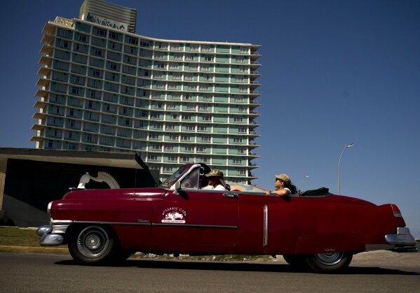 
              A vintage American car carries tourists next to hotel Riviera, managed by the Spanish company Iberostar, in Havana, Cuba, Wednesday, April 24, 2019. The European Union ambassador to Cuba says the Trump administration's crackdown on business with the communist government is causing unprecedented concern among European companies doing business on the island. (AP Photo/Ramon Espinosa)
            