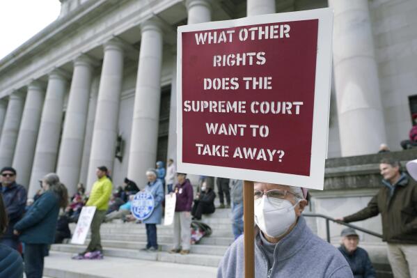 FILE - A person holds a sign referencing the U.S. Supreme Court as they take part in a rally in favor of abortion rights on the steps of the Temple of Justice, which houses the Washington state Supreme Court, Tuesday, May 3, 2022, at the Capitol in Olympia, Wash. (AP Photo/Ted S. Warren, File)