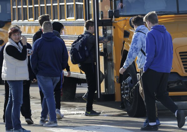 Students are evacuated from the scene of an officer invloved shooting at Oshkosh West High School after an armed student confronted a school resource officer on Tuesday December 3, 2019, at in Oshkosh, Wis. Police in Oshkosh say a police officer and an armed student whom he confronted at the school were both wounded in the confrontation Tuesday morning. (Wm. Glasheen/The Post-Crescent via AP)