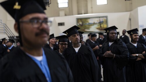 Incarcerated graduates, who finished various educational and vocational programs in prison, wait for the start of their graduation ceremony at Folsom State Prison in Folsom, Calif., Thursday, May 25, 2023. Thousands of prisoners throughout the United States get their college degrees behind bars, most of them paid for by the federal Pell Grant program, which offers the neediest undergraduates tuition aid that they don’t have to repay. That program is about to expand exponentially next month, giving about 30,000 more students behind bars some $130 million in financial aid per year. (AP Photo/Jae C. Hong)