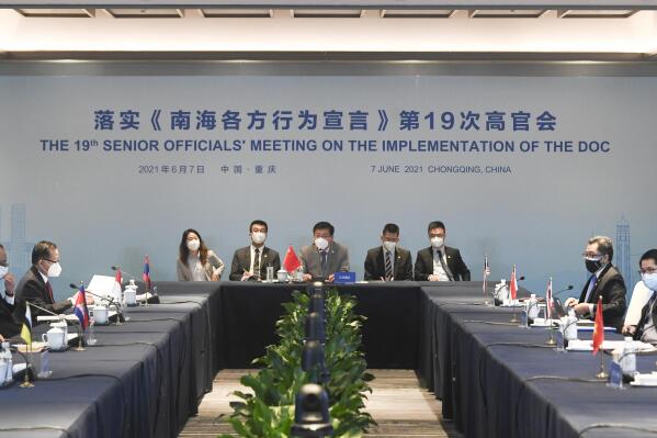 In this photo released by Xinhua News Agency, officials from China and the Association of Southeast Asian Nations (ASEAN) countries attend the 19th Senior Officials' Meeting on the Implementation of the Declaration on the Conduct of Parties in the South China Sea (DOC) in Chongqing, southwestern China, June 7, 2021. China is hosting foreign ministers from 10 Southeast Asian nations this week in the southwestern megacity of Chongqing amid heightened competition between Beijing and Washington for influence in the region. (Wang Quanchao/Xinhua via AP)