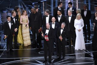 Jordan Horowitz, foreground center, and the cast of "La La Land" mistakenly accept the award for best picture at the Oscars on Sunday, Feb. 26, 2017, at the Dolby Theatre in Los Angeles. It was later announced that "Moonlight," was the winner for best picture. (Photo by Chris Pizzello/Invision/AP)