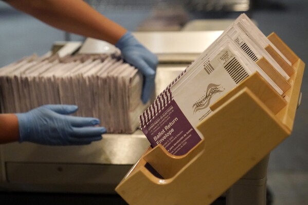 FILE - In this Nov. 1, 2020, file photo, envelopes containing ballots are shown at a San Francisco Department of Elections at a voting center in San Francisco. Democratic infighting is rattling elections in California swing districts that could be key to U.S. House control. Democrats are hoping to regain seats the party lost to the GOP in 2020 in the heavily Democratic state. But rival Democrats are trading attacks that could undercut the party's chances. (AP Photo/Jeff Chiu, File)