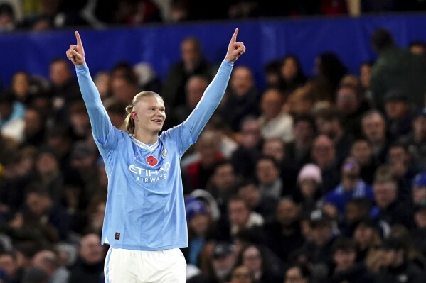 Manchester City's Erling Haaland celebrates after scoring his side's opening goal during the English Premier League soccer match between Chelsea and Manchester City at Stamford Bridge stadium in London, Sunday, Nov. 12, 2023. (John Walton/PA via AP)