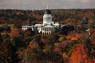 FILE - In this Oct. 23, 2017, file photo, the State House is surrounded by fall foliage in Augusta, Maine. The Democratic-led state Senate voted Tuesday, June 4, 2019, to legalize doctor-assisted suicide. The house approved it the day before. The office of Gov. Janet Mills said she has not yet taken a position on the bill. (AP Photo/Robert F. Bukaty, File)