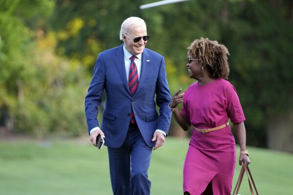 President Joe Biden walks across the South Lawn of the White House as he talks with White House press secretary Karine Jean-Pierre Thursday, May 2, 2024, in Washington, after returning from a trip to North Carolina. (AP Photo/Mark Schiefelbein)