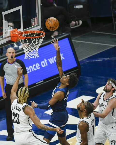Minnesota Timberwolves forward Jaden McDaniels, second from left, goes up for a shot as Brooklyn Nets forward Nicolas Claxton, left, Nets forward Kevin Durant, second from right, and Nets forward Joe Harris look on during the first half of an NBA basketball game Tuesday, April 13, 2021, in Minneapolis. (AP Photo/Craig Lassig)