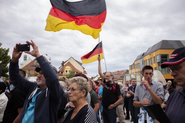 FILE - In this Thursday, Aug. 15, 2019 file photo, people attend an election rally of the far-right Alternative for Germany, or AfD, party for the Saxony state elections in Bautzen, Germany. Millions of Germans have joined rallies all over the country and even held weekly vigils in their neighborhoods to express their frustration with growing support for far-right populism at the ballot box. (AP Photo/Markus Schreiber, File)